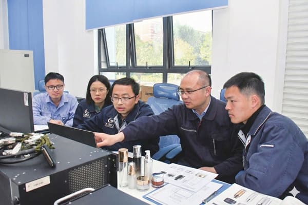 Expert technical team at Ximu Packaging collaborating on engineering solutions for cosmetic packaging and material compatibility.